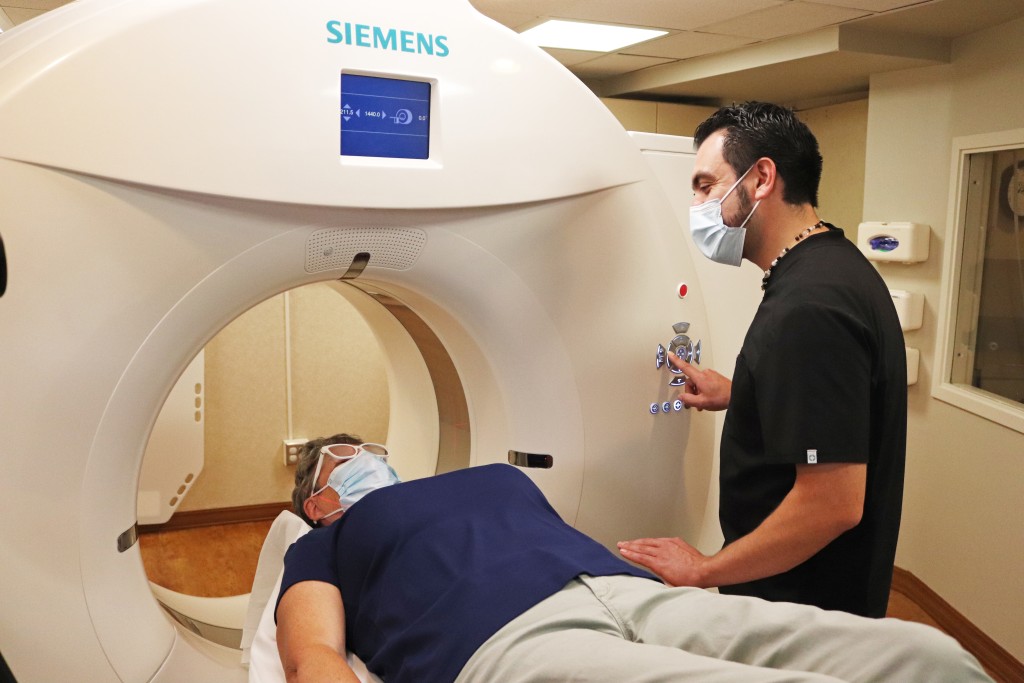 BVRMC employee helping a female patient during their computerized tomography (CT) scan.