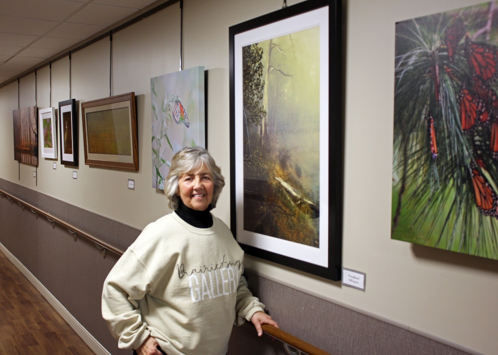 Marilyn-Tamm Schmitt standing next to her artwork at BVRMC
