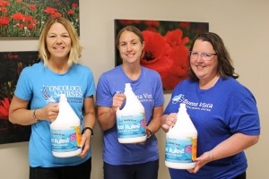 BVRMC employees holding gallons of sunscreen