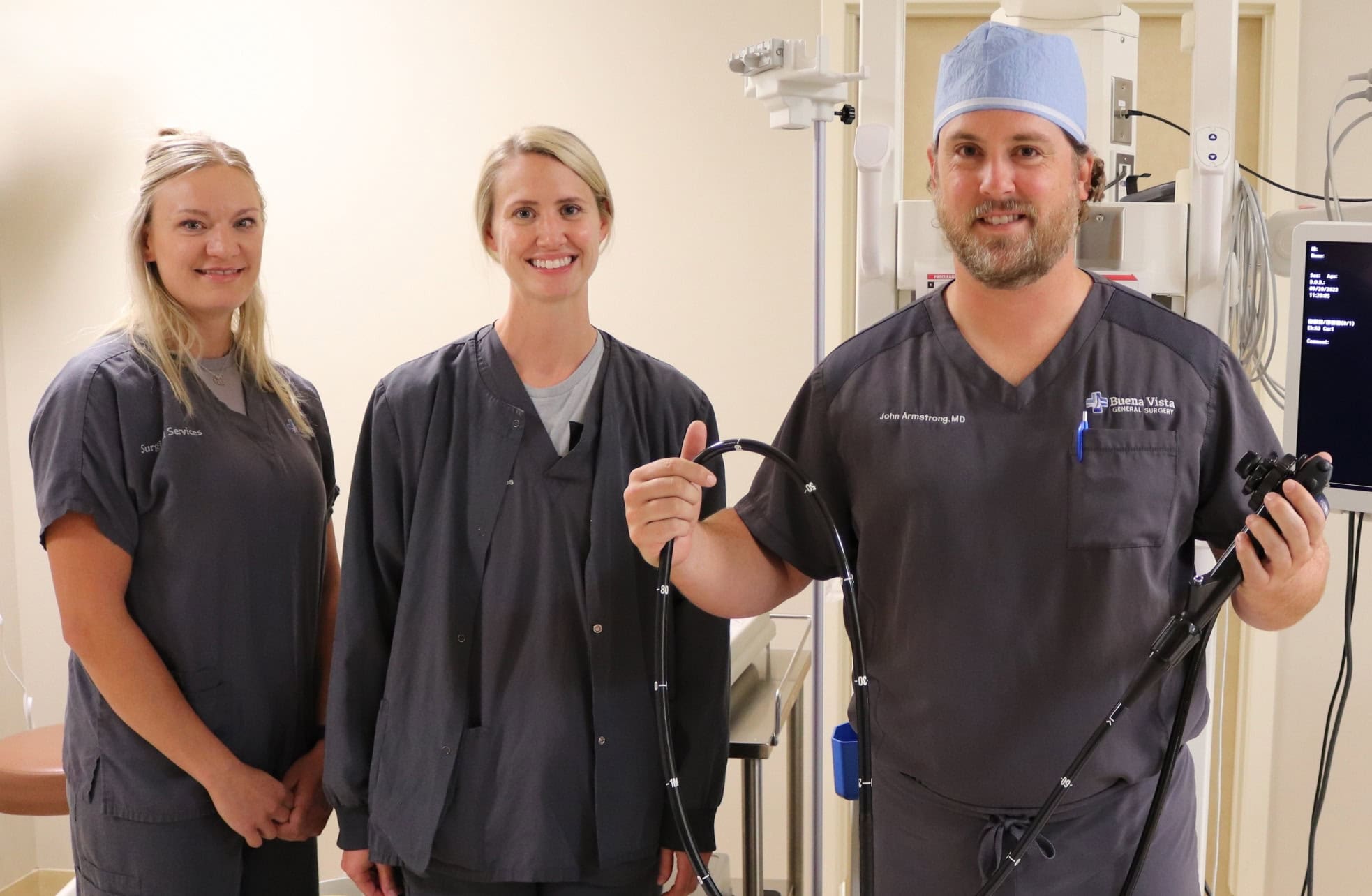 Nuses and Dr. Armstrong in front of and holding scope equipment.