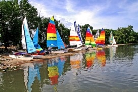 Sailboats lined up along the shore of Storm Lake