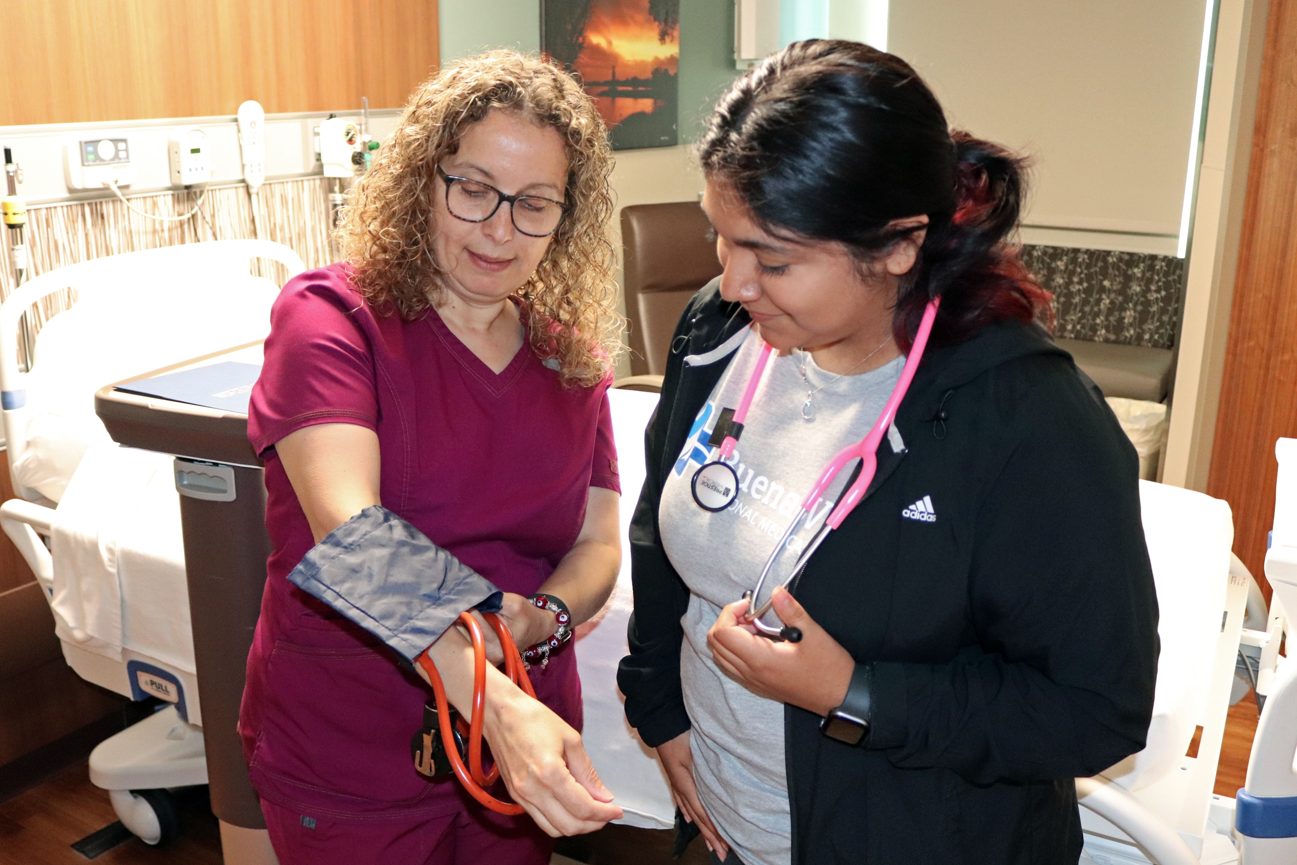 BVRMC CNA demonstrates a blood pressure tool to a high school student intern